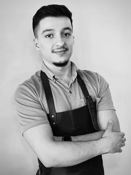 Portrait of Jimmy, master barber and stylist at Monteman Barber